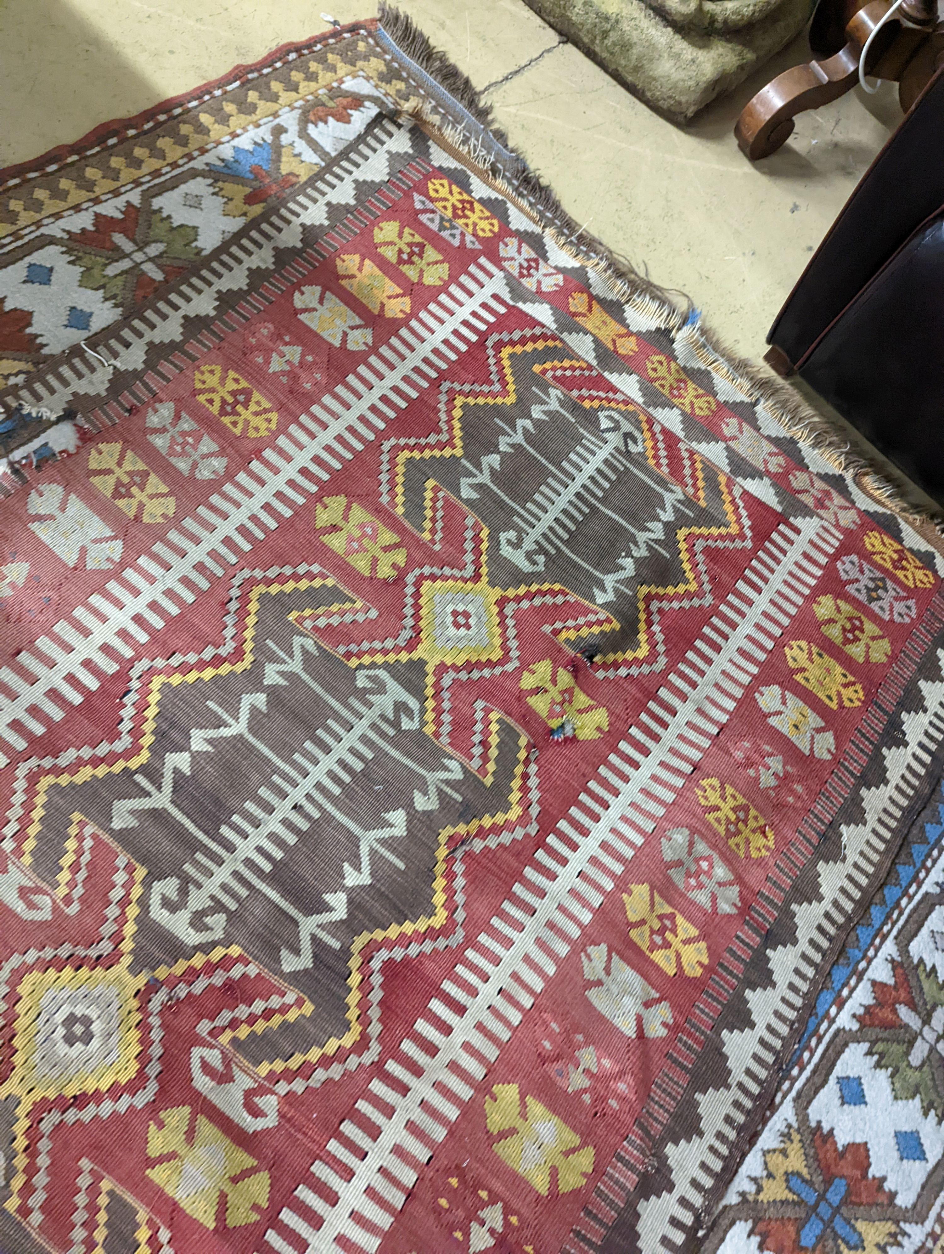 A Kilim polychrome flatweave runner, 380 x 118cm (holed)